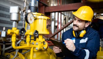 Working in natural gas refinery plant checking supply and distribution.